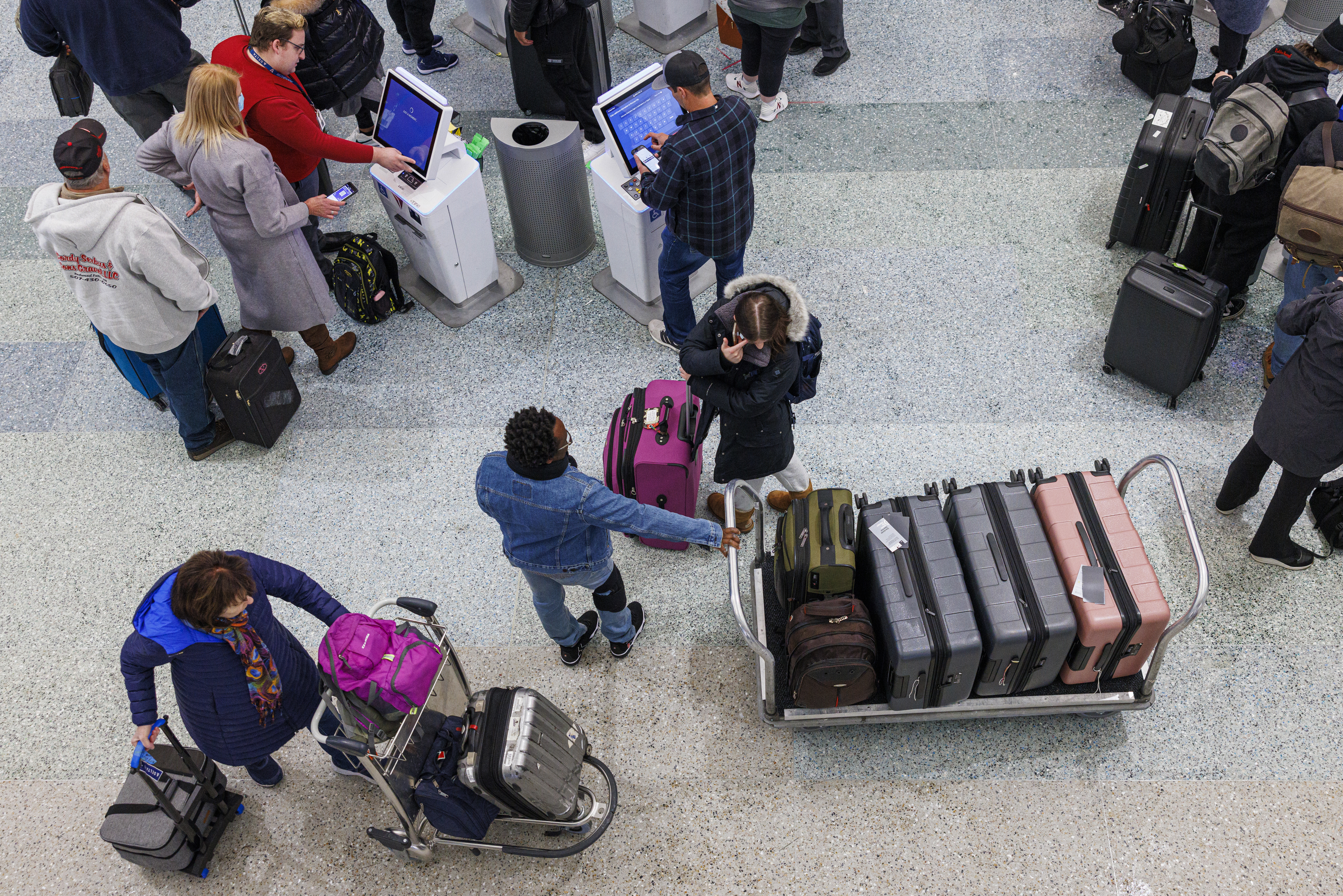 Travelers wait in line to check-in for their flights at Terminal 1 ahead of the Christmas Holiday at MSP Airport in Bloomington, Minn., on Thursday, Dec. 22, 2022. (Kerem Yücel /Minnesota Public Radio via AP)