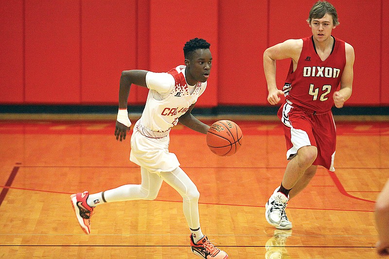 Calvary Lutheran’s Kwesi Hall brings the ball up the court during Wednesday’s game against Dixon at Calvary Lutheran High School. (Greg Jackson/News Tribune)