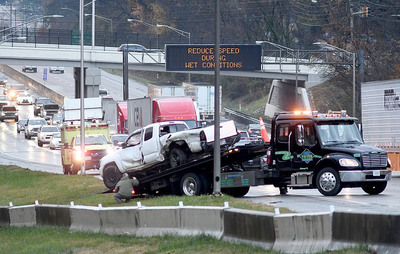 Staff Photo by Robin Rudd /  A crew from Doug Yates Towing and Recovery removes a vehicle from a early morning accident on Interstate 24, between Belvior and Germantown Roads, last month.