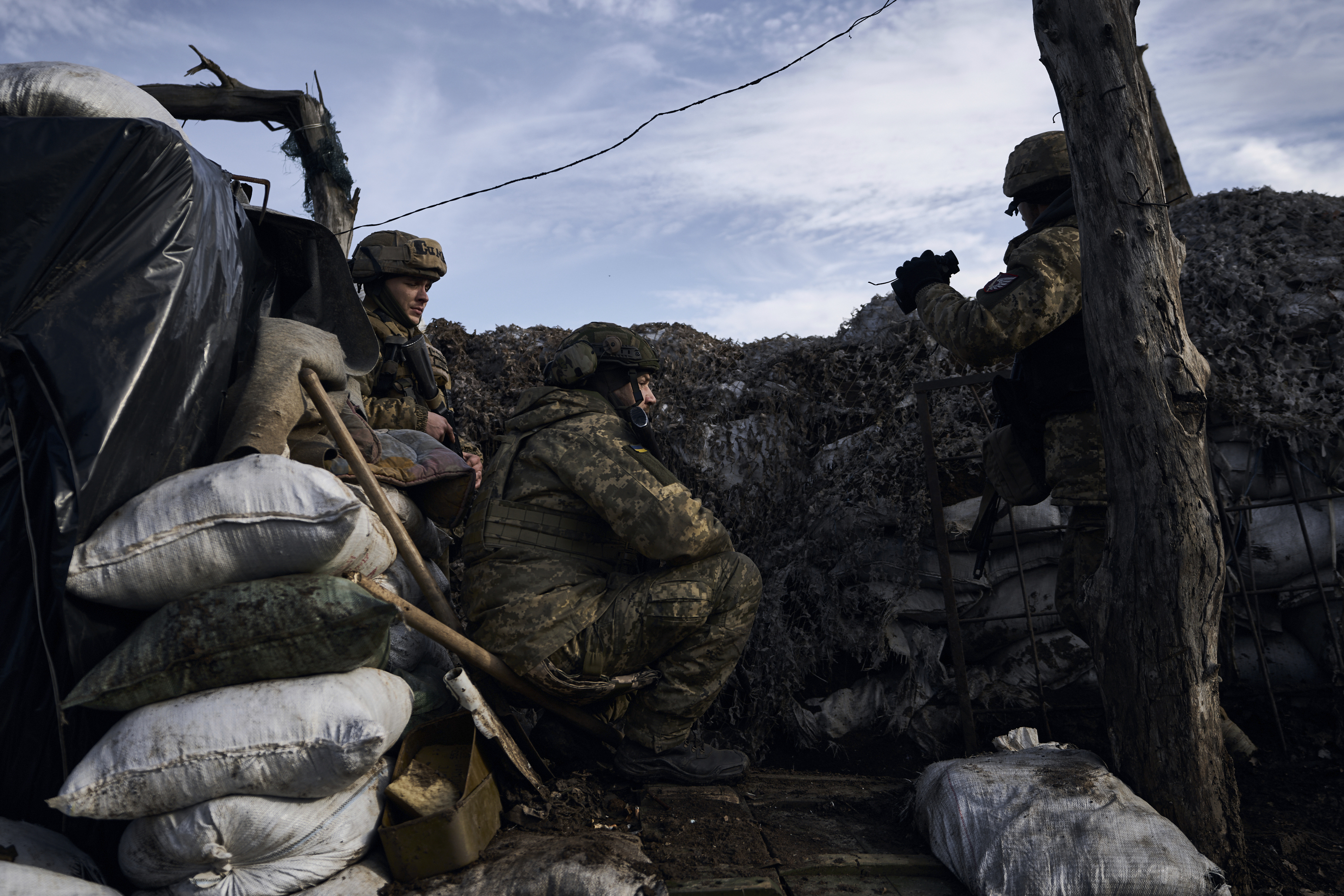 Ukrainian soldiers take position during fights with Russian forces near Maryinka, Donetsk region, Ukraine, Friday, Dec. 23, 2022. (AP Photo/Libkos)