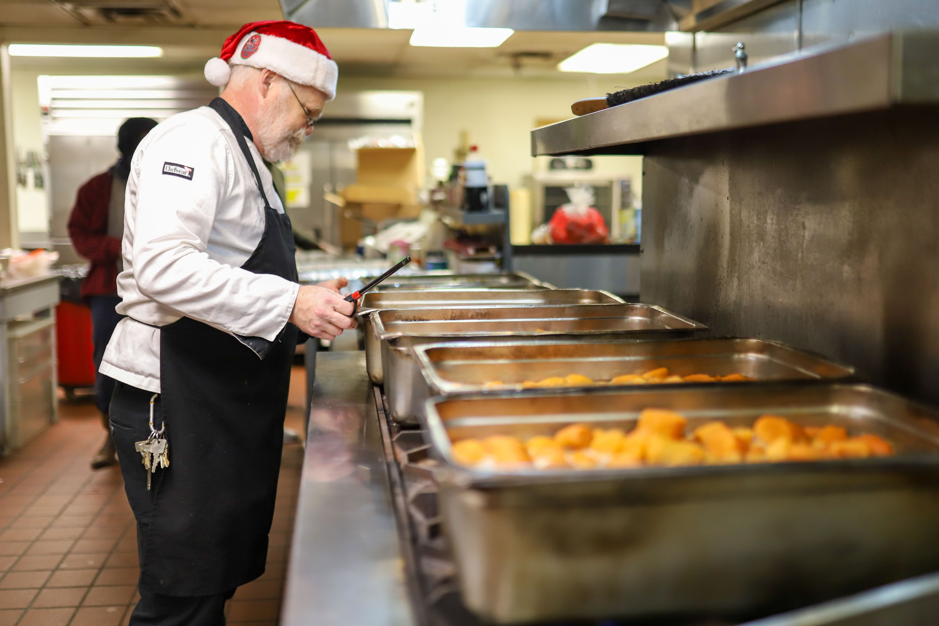 Staff photo by Olivia Ross  / Chef Danny Heath prepares the meals. The Community Kitchen held a Christmas Celebration with a holiday meal, Santa, and presents for all ages on Sunday, December 25, 2022.
