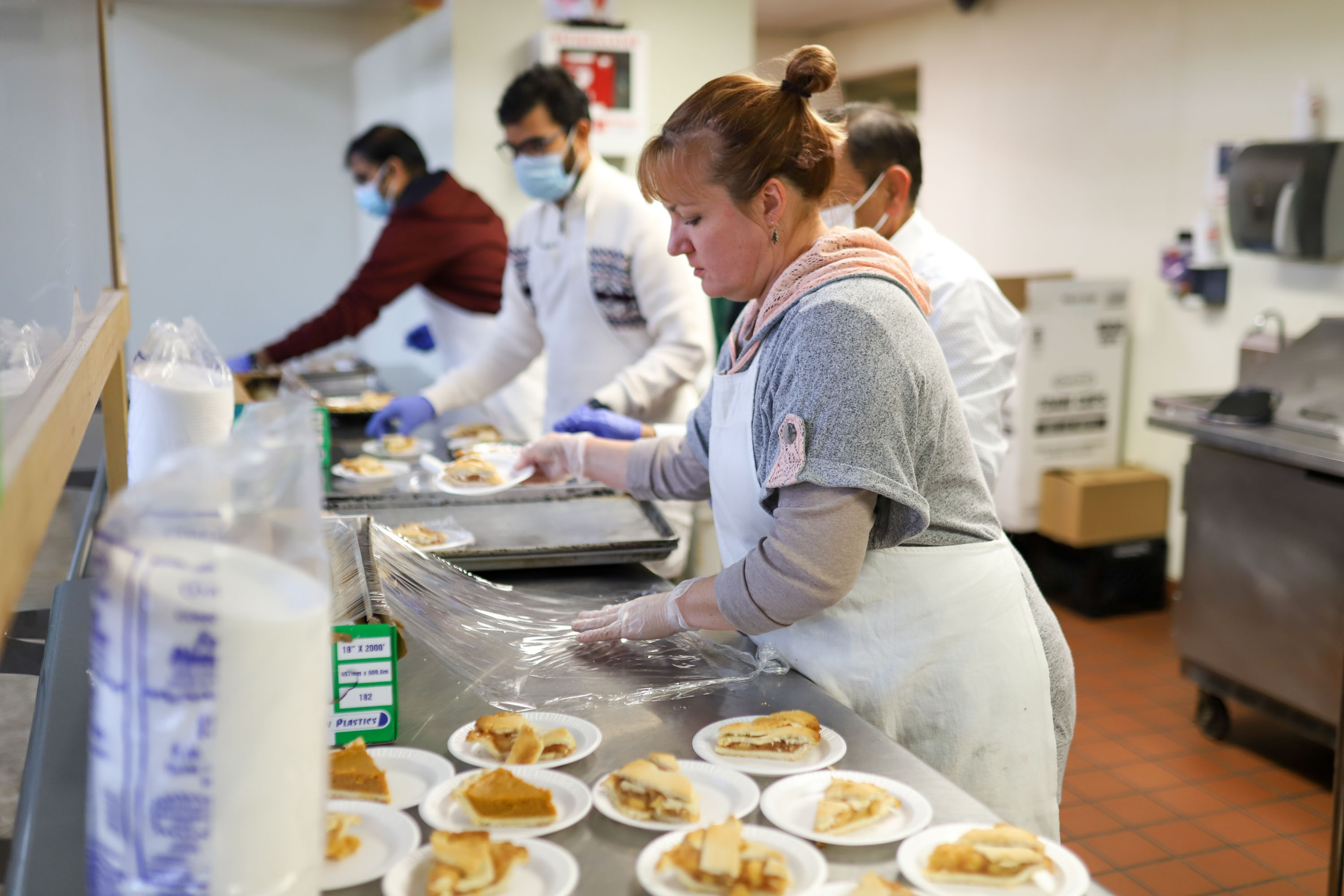 Staff photo by Olivia Ross  / Theresa Rogers helps the other volunteers plate slices of pie. The Community Kitchen held a Christmas Celebration with a holiday meal, Santa, and presents for all ages on Sunday, December 25, 2022.