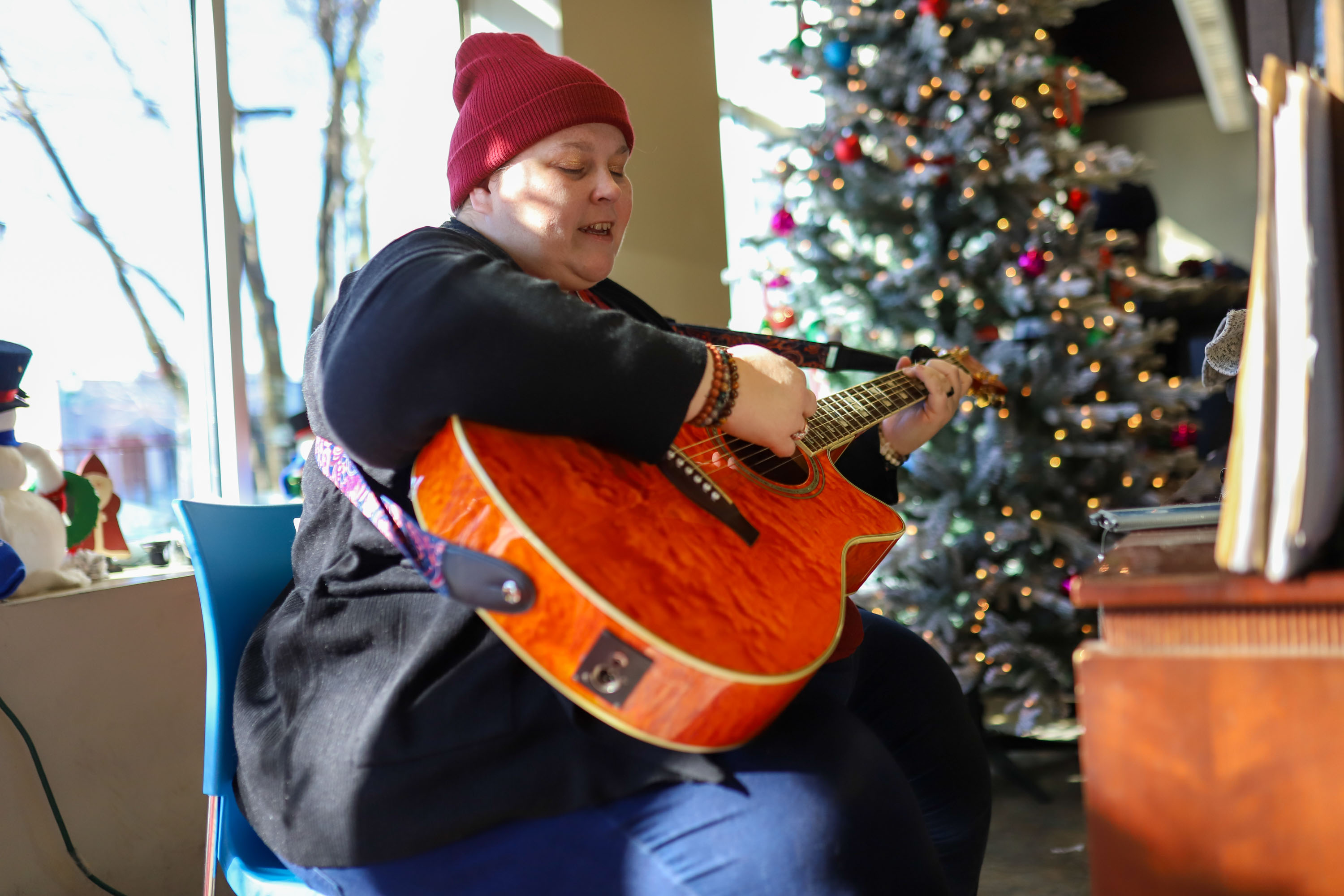 Staff photo by Olivia Ross  / Karin Rochelle sings Jingle Bells while presents are handed out. The Community Kitchen held a Christmas Celebration with a holiday meal, Santa, and presents for all ages on Sunday, December 25, 2022.