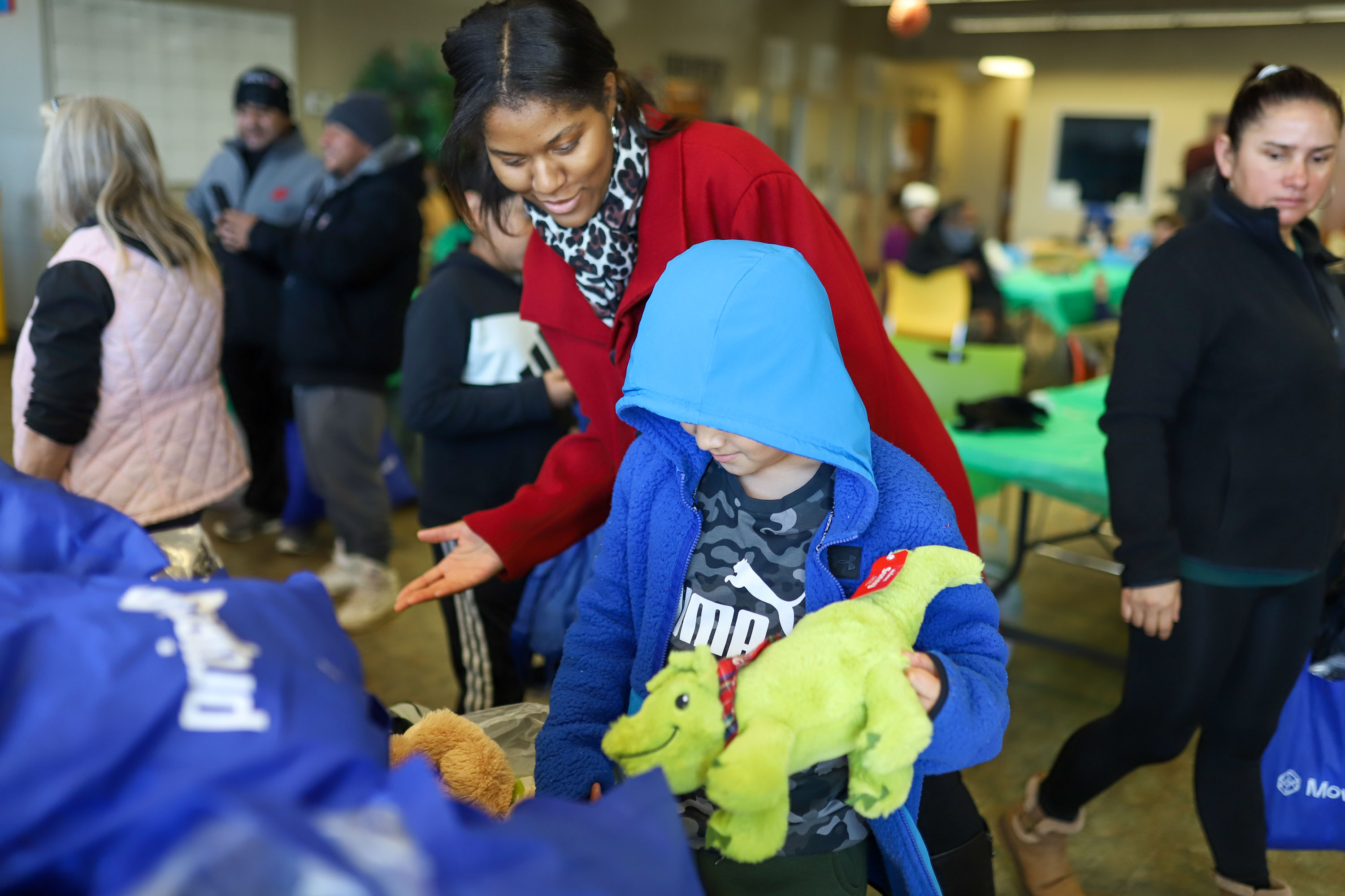 Staff photo by Olivia Ross  / Germyah Batey helps hand out presents. The Community Kitchen held a Christmas Celebration with a holiday meal, Santa, and presents for all ages on Sunday, December 25, 2022.