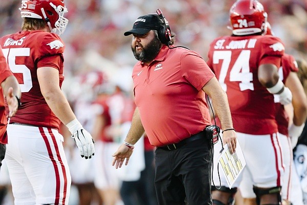 Arkansas offensive line coach Cody Kennedy congratulates players as they walk off the field following a score, Saturday, September 17, 2022 during the second quarter of a football game at Donald W. Reynolds Razorback Stadium in Fayetteville.