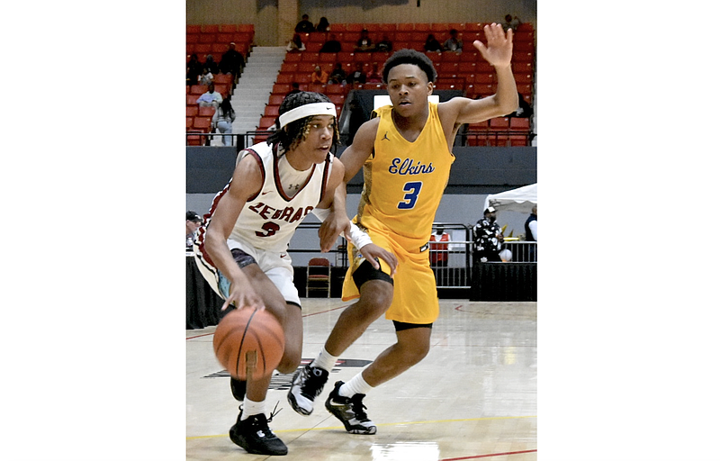 Braylen Hall of Pine Bluff dribbles past Tim Keeter of Fort Bend (Texas) Elkins in the third quarter Tuesday at the King Cotton Holiday Classic. (Pine Bluff Commercial/I.C. Murrell)