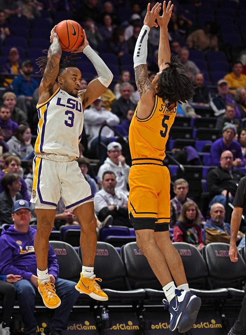 LSU guard Justice Hill (3) passes the ball around East Tennessee State guard Allen Strothers (5), Wednesday, December 21, 2022, at the LSU PMAC in Baton Rouge, La.