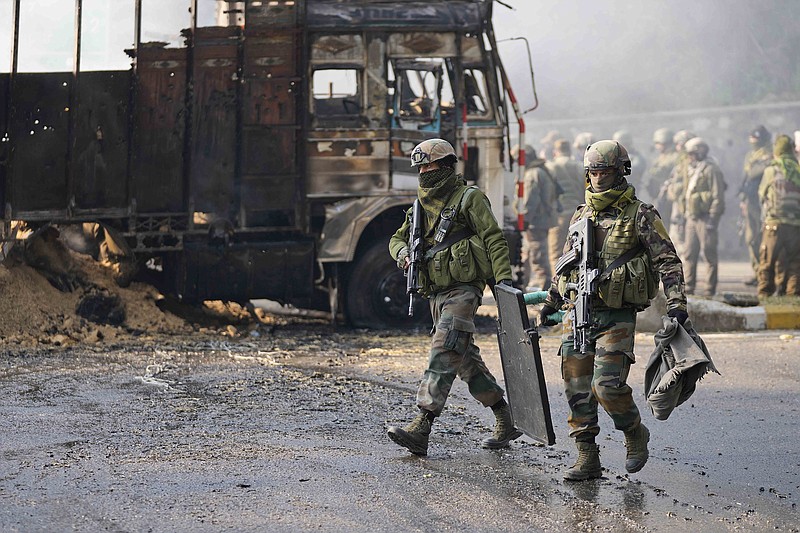Indian army soldiers walk at the site of a gunbattle at Nagrota on the Jammu-Srinagar highway in Indian-controlled Kaon Wednesday.
(AP/Channi Anand)