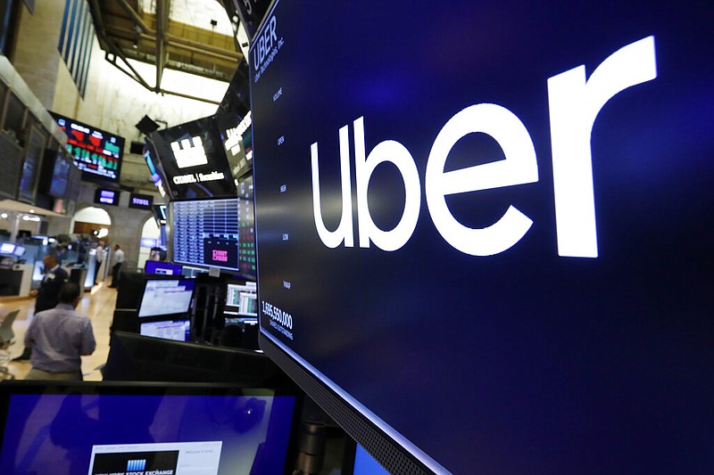 FILE - The logo for Uber appears above a trading post on the floor of the New York Stock Exchange, Friday, Aug. 9, 2019. (AP/Richard Drew)