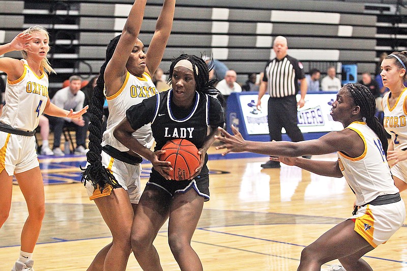 Capital City’s Jada Anderson tries to work the ball inside between CC Frierson (left) and Zoe Metcalf (right) of Oxford, Miss., during Thursday’s loser’s bracket semifinal game of the Jefferson Bank Holiday Hoops Classic at Capital City High School. (Greg Jackson/News Tribune)