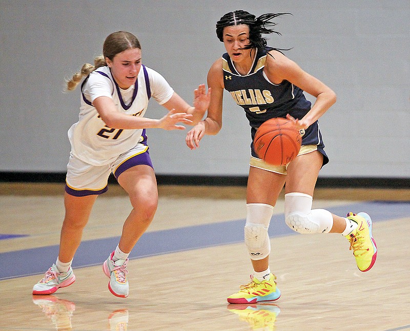 Claire Galbraith of Helias steals the ball away from Hickman’s Ashtyn Klusmeyer during Thursday’s winner’s bracket semifinal game in the Jefferson Bank Holiday Hoops Classic at Capital City High School. (Greg Jackson/News Tribune)