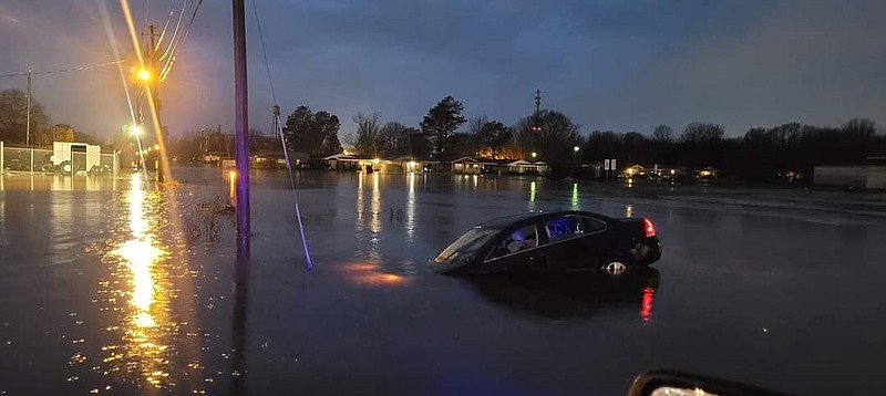 A vehicle pictured Tuesday goes underwater as a result of overnight flooding in Stuttgart. (Special to The Commercial/Paul Colvin)