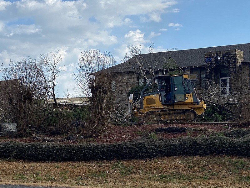 Heavy equipment is used to clear debris in front of Jessieville High School on Tuesday, Jan. 3, 2022 after a suspected tornado caused damage in the area. (Arkansas Democrat-Gazette/Colin Murphey)
