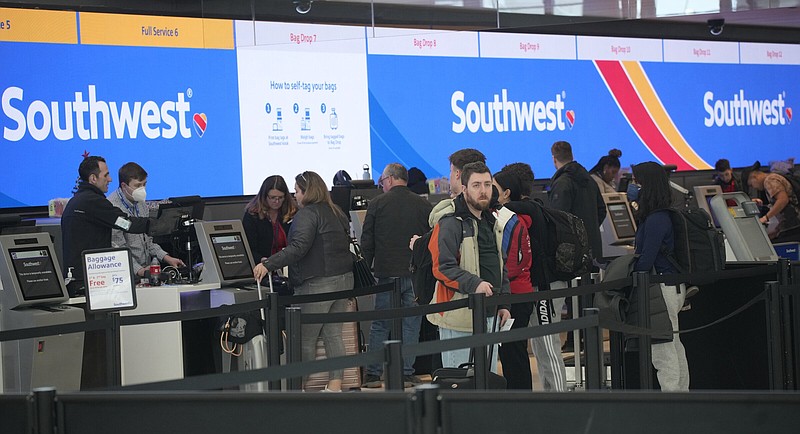 Travelers line up at the check–in counters for Southwest Airlines in Denver International Airport on Dec. 30.
(AP/David Zalubowski)