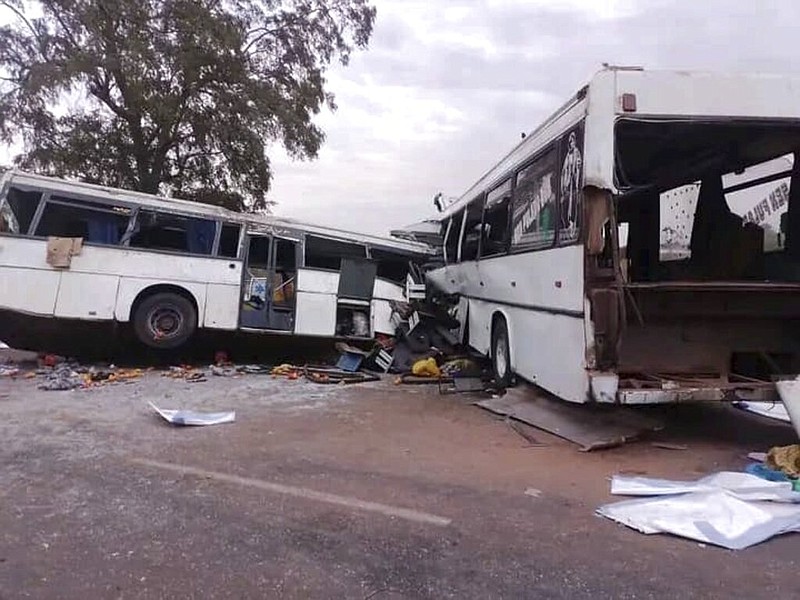 Two damaged buses are pictured after they collided on a road in Gniby, Senegal, Sunday Jan. 8, 2023. (Elimane Fall via AP)