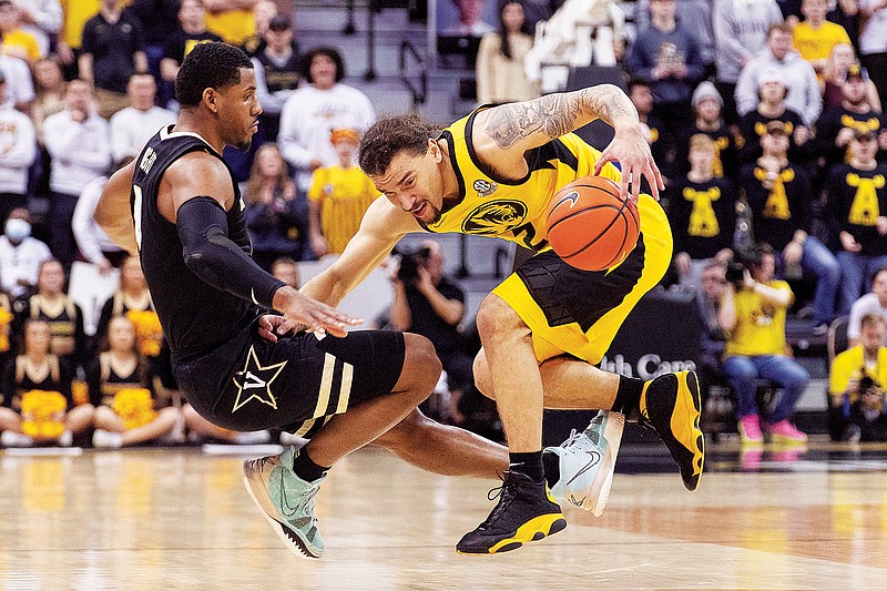 Tre Gomillion of Missouri falls to the court after he was fouled by Vanderbilt’s Jordan Wright during Saturday’s game at Mizzou Arena in Columbia. (Associated Press)