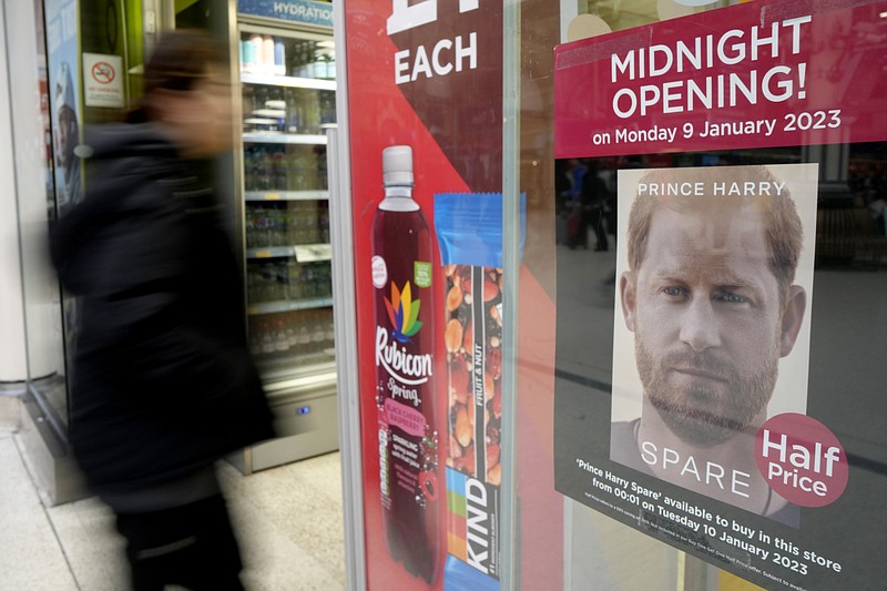 A poster advertises the midnight opening of a store to sell the new book by Prince Harry called 'Spare' in London, Monday, Jan. 9, 2023. Prince Harry has defended his memoir that lays bare rifts inside Britain's royal family. He says in TV interviews broadcast Sunday that he wanted to "own my story" after 38 years of "spin and distortion" by others. Harry's soul-baring new memoir, "Spare," has generated incendiary headlines even before its release. (AP Photo/Kirsty Wigglesworth)
