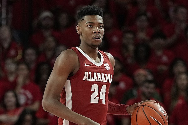 Alabama forward Brandon Miller (24) advances the ball during the first half of an NCAA college basketball game against Houston, Saturday, Dec. 10, 2022, in Houston. (AP Photo/Kevin M. Cox)