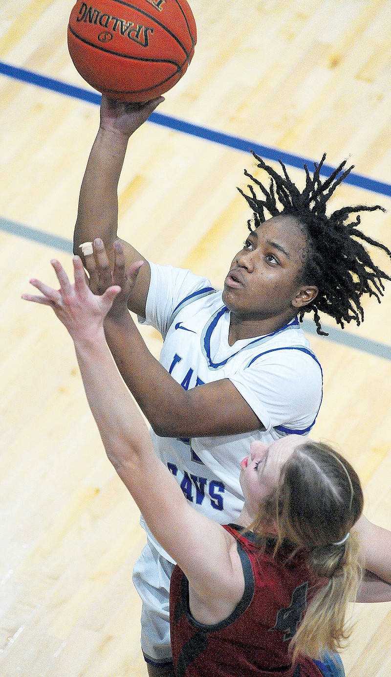 Danijah Fluellen of Capital City goes up for a shot during Monday night’s game against Warrensburg at Capital City High School. (Shaun Zimmerman/News Tribune)