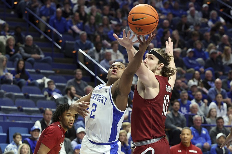 Kentucky's Sahvir Wheeler (2) shoots while pressured by South Carolina's Hayden Brown (10) during the first half of an NCAA college basketball game in Lexington, Ky., Tuesday, Jan. 10, 2023. (AP Photo/James Crisp)
