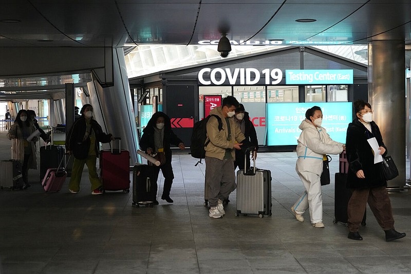 Passengers arriving from China pass by a covid-19 testing center at the Incheon International Airport In Incheon, South Korea, Tuesday, Jan. 10, 2023. (AP/Ahn Young-joon)