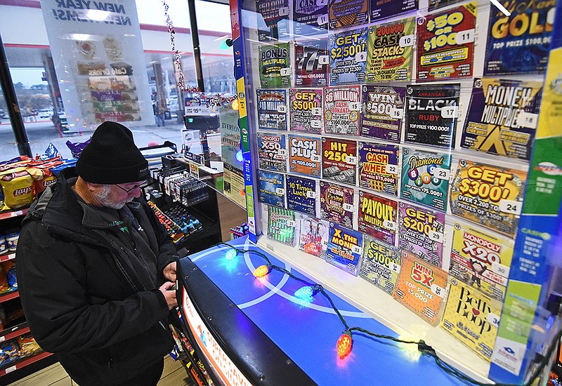 John Foster of Maumelle buys a lottery ticket Thursday at the Murphy Express at the corner of Chenal Parkway and Markham Street in Little Rock.
(Arkansas Democrat-Gazette/Staci Vandagriff)