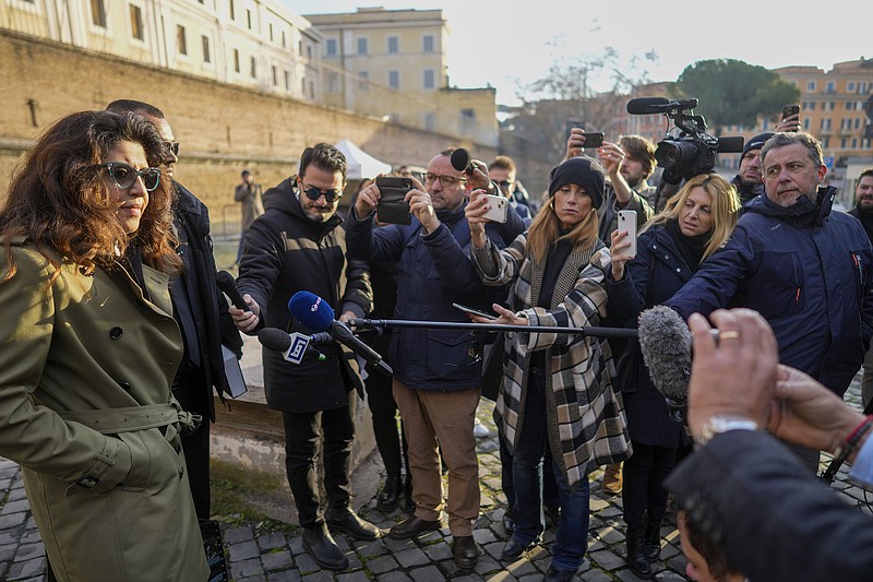 Francesca Chaouqui (left), former financial consultant for the Vatican, talks to reporters Friday as she arrives to testify before the city-state’s criminal tribunal at the Vatican.
(AP/Andrew Medichi)