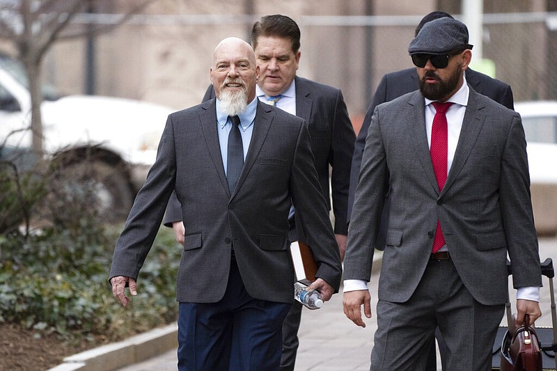 Richard "Bigo" Barnett (left) arrives at federal court in Washington with his attorneys, Joseph McBride (right) and Bradford Geyer (second from right), in this Tuesday, Jan. 10, 2023 file photo. Barnett of Gravette was photographed with his feet on a desk in the office of then-House Speaker Nancy Pelosi during the Jan. 6 U.S. Capitol riot. (AP/Manuel Balce Ceneta)