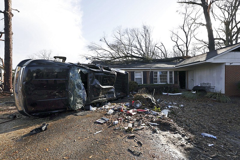 A vehicle is upended and debris is strewn about follow a tornado near Meadowview elementary school Thursday, Jan. 12, 2023 in Selma Ala. (AP Photo/Butch Dill)