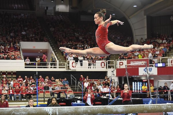 Arkansas' Norah Flatley competes Friday, Jan. 13, 2022, in the bar competition of the Razorbacks' meet with Alabama in Barnhill Arena in Fayetteville.