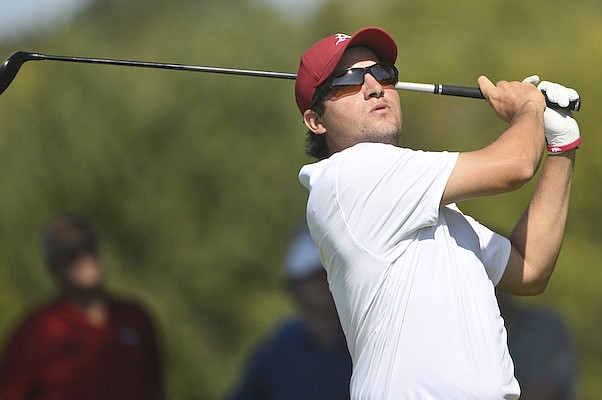 Arkansas golfer Mateo Fernandez De Oliveira watches his tee shot on the fourth hole during an NCAA golf tournament on Wednesday, Oct. 5, 2022, in Johnson. (AP Photo/Michael Woods).