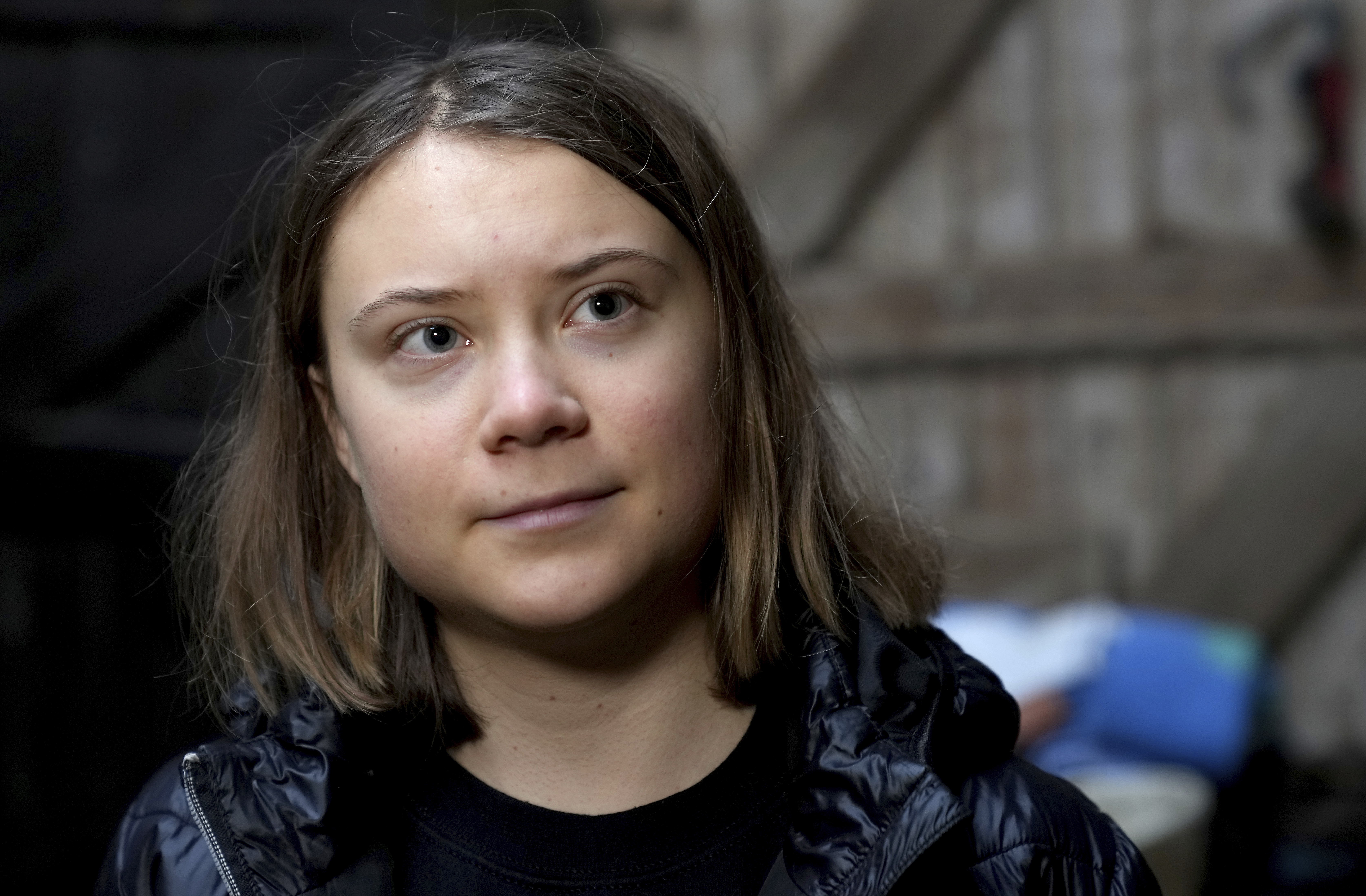 Swedish climate campaigner Greta Thunberg looks on during an interview with the Associated Press in Erkelenz, Germany, Saturday, Jan. 14, 2023. Ahead of a demonstration in which she will take part nearby on Saturday, Thunberg on Friday visited the tiny village of Luetzerath and took a look at the nearby Garzweiler open coal mine. (AP Photo/Michael Probst)