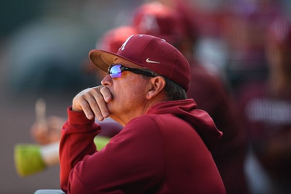 Arkansas coach Dave Van Horn watches from the dugout Thursday, Oct. 13, 2022, before the start of play against the Texas Rangers Instructional League team at Baum-Walker Stadium in Fayetteville.
