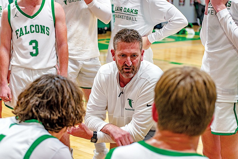 Blair Oaks boys coach Ryan Fick talks to his players in a huddle during Friday night’s game against Versailles at Blair Oaks High School in Wardsville. Fick picked up career victory No. 400 in Blair Oaks’ 80-64 win. (Ken Barnes/News Tribune)