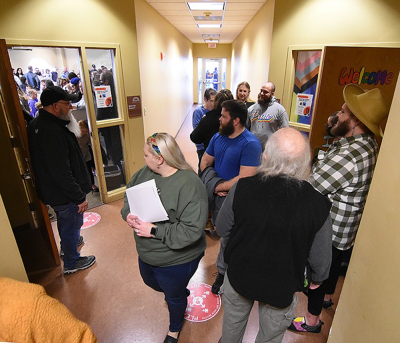 People walk through the hallway between the two storytime rooms Saturday at the Faulkner County Library in Conway.
(Arkansas Democrat-Gazette/Staci Vandagriff)