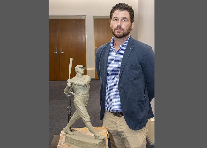 Artist Chad Fisher poses at Horner Hall in the Hot Springs Convention Center with a model of Majestic Park's Babe Ruth statue in this Sept. 27, 2021 file photo. The statue is scheduled to be unveiled in a ceremony at the park on Feb. 6. (Arkansas Democrat-Gazette/Cary Jenkins)