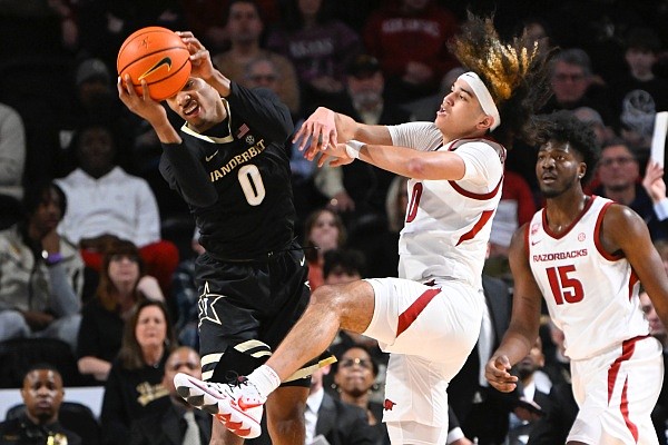 Vanderbilt guard Tyrin Lawrence (0) and Arkansas guard Anthony Black (0) battle for a rebound during the second half of a game on Saturday, Jan. 14, 2023, in Nashville, Tenn. Vanderbilt won 97-84. (AP Photo/John Amis) Vanderbilt guard Tyrin Lawrence (0) and Arkansas guard Anthony Black (0) battle for a rebound during the second half of a game on Saturday, Jan. 14, 2023, in Nashville, Tenn. Vanderbilt won 97-84. (AP Photo/John Amis)
