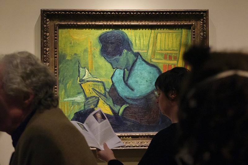 Visitors file past at the Van Gogh painting "Une Liseuse De Romans", also known as "The Novel Reader", during the Van Gogh in America exhibit at the Detroit Institute of Arts, Wednesday, Jan. 11, 2023, in Detroit. (Andy Morrison/Detroit News via AP)