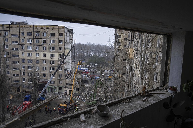 Rescue workers clear the rubble from an apartment building that was destroyed in a Russian rocket attack at a residential neighbourhood in the southeastern city of Dnipro, Ukraine, Monday, Jan. 16, 2023. (AP/Evgeniy Maloletka)