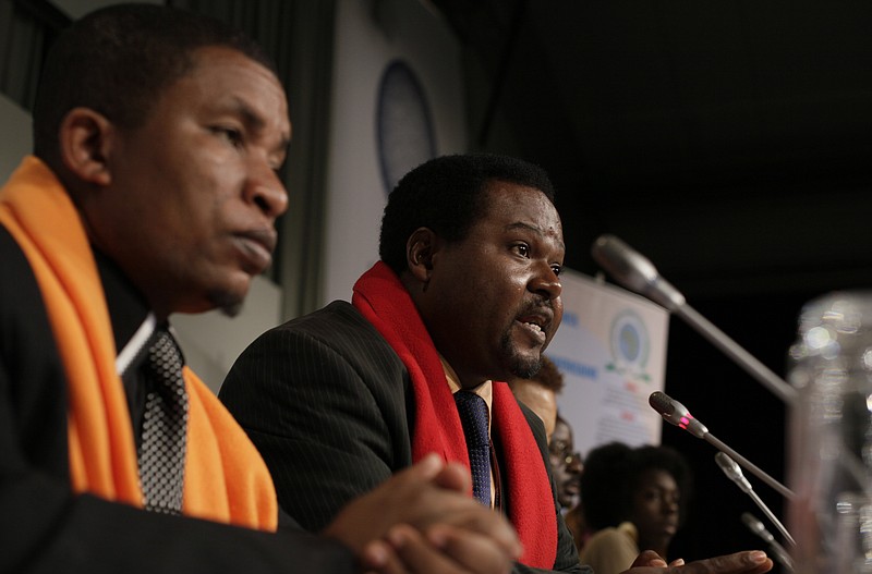 FILE - Coordinator Mithika Mwenda, left, and committee member Augustine Njamnshi, right,at a press conference of the Pan African Climate Justice Alliance at the Climate Summit, in Copenhagen Denmark, on Dec. 10, 2009. Climate activists in Africa have expressed anger toward the United Nations climate agency, accusing it of allowing corporations and individuals with “dubious” climate credentials to “greenwash” their polluting activities by participating in its annual climate conference. The criticism follows Thursday’s announcement that oil executive Sultan al-Jaber will lead the next round of U.N. climate talks, which will be held in the United Arab Emirates in late November. “This is the textbook definition of impunity and conflict of interest," Mithika Mwenda, PACJA's executive director said in statement Monday. (AP Photo/Peter Dejong)