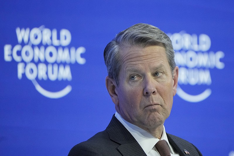 From left: US Gov. Brian Kemp of Georgia, attends a panel at the World Economic Forum in Davos, Switzerland Tuesday, Jan. 17, 2023. The annual meeting of the World Economic Forum is taking place in Davos from Jan. 16 until Jan. 20, 2023. (AP Photo/Markus Schreiber)