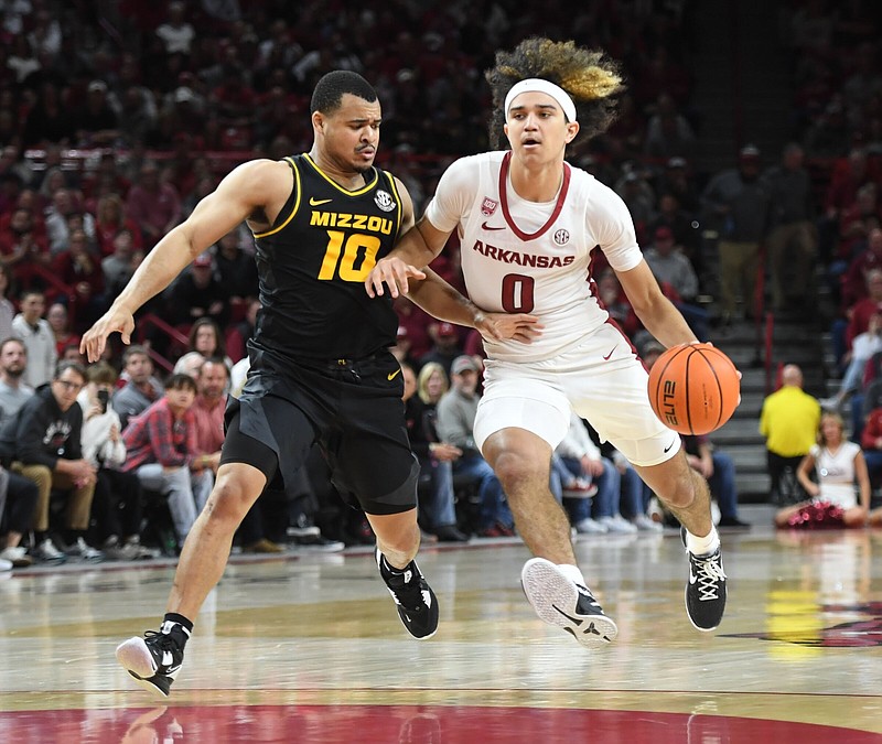 Arkansas guard Anthony Black (0) drives to the lane Wednesday, Jan. 4, 2023, as Missouri wing Nick Honor applies pressure during the second half of the RazorbacksÕ 74-68 win in Bud Walton Arena in Fayetteville. Visit nwaonline.com/photo for today's photo gallery. .(NWA Democrat-Gazette/Andy Shupe)