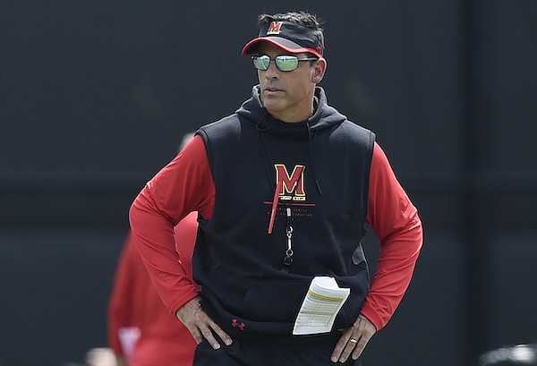 Maryland football offensive coordinator Dan Enos looks over an NCAA college football practice, Friday, Aug. 6, 2021 in College Park, Md.(AP Photo/Gail Burton)