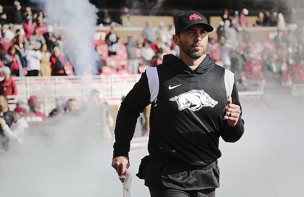 Arkansas offensive coordinator Kendal Briles runs onto the field prior to a game against LSU on Saturday, Nov. 12, 2022, in Fayetteville.