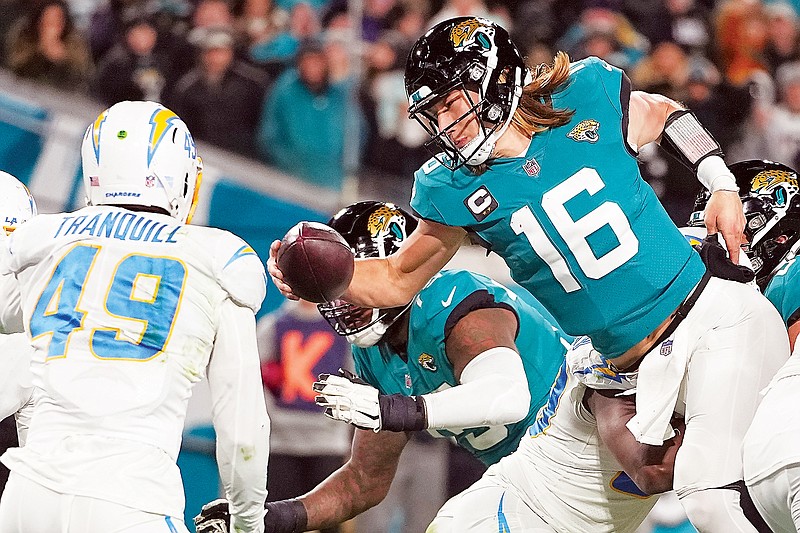 Jaguars quarterback Trevor Lawrence leaps for a 2-point conversion during last Saturday night’s wild-card game against the Chargers in Jacksonville, Fla. (Associated Press)