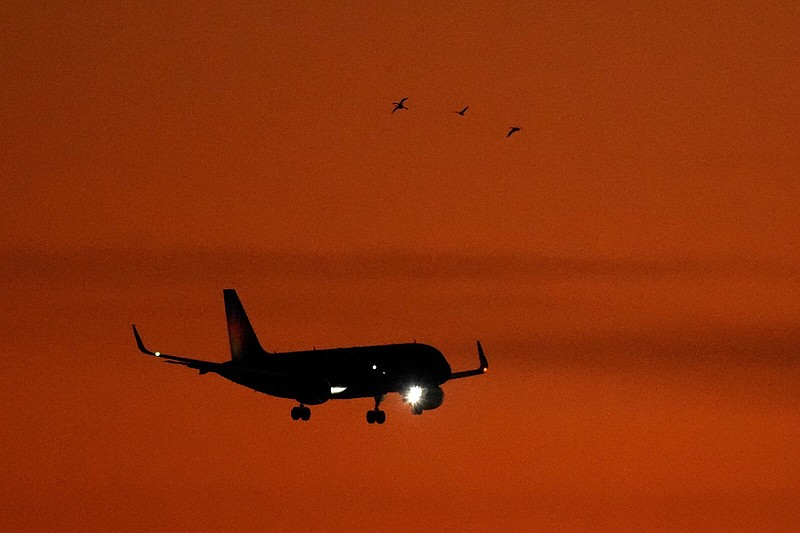 An Allegiant Air passenger jet nears Kansas City International Airport for landing in December as geese fly overhead.
(AP/Charlie Riedel)