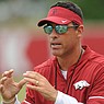 Arkansas offensive coordinator Dan Enos speaks to his players Tuesday, Aug. 1, 2017, during practice at the university's practice field in Fayetteville.