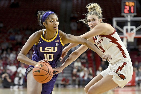 LSU forward Angel Reese (10) tries to drive past Arkansas guard Saylor Poffenbarger (0) during an NCAA basketball game on Thursday, Dec. 29, 2022, in Fayetteville. (AP Photo/Michael Woods)