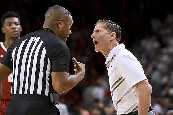 Arkansas coach Eric Musselman has a word with an official after a call during the second half of the team's NCAA college basketball game against Alabama on Wednesday, Jan. 11, 2023, in Fayetteville. (AP Photo/Michael Woods)