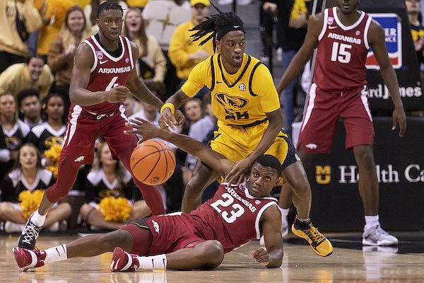 Arkansas' Derrian Ford, bottom, and Missouri's Sean East II, top, chase a loose ball during the first half of an NCAA college basketball game Wednesday, Jan. 18, 2023, in Columbia, Mo. (AP Photo/L.G. Patterson)